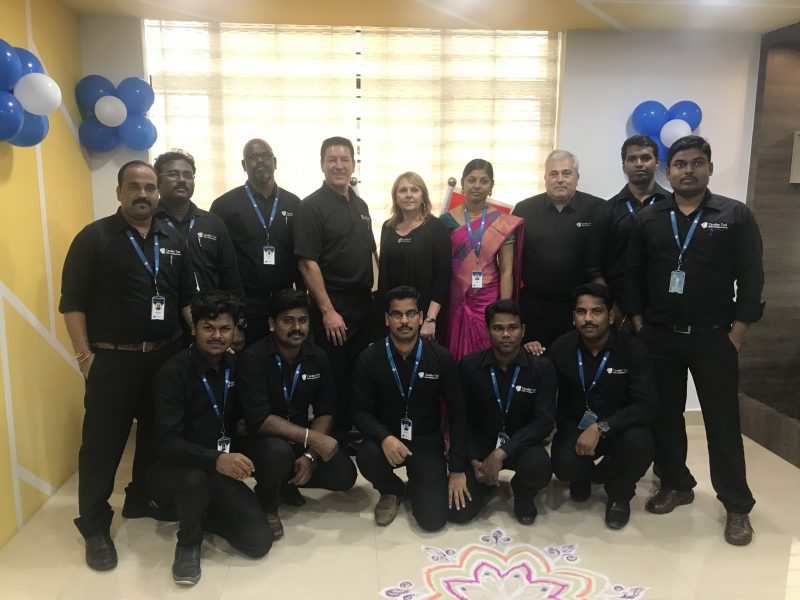 President Brian Bendig and General Manager Brenda Quint posing with the staff of Cavalier Tool India