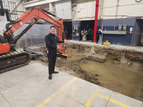 Brian Bendig, Cavalier Tool President, stands at the side of a large pit where an Okuma Bridge Mill will soon be installed.