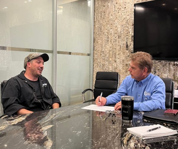 Nathan's trainer Chad smiling as he talks to Richard Janik about Nathan's technical objectives for his placement in the Career Ready Program with CTMA.